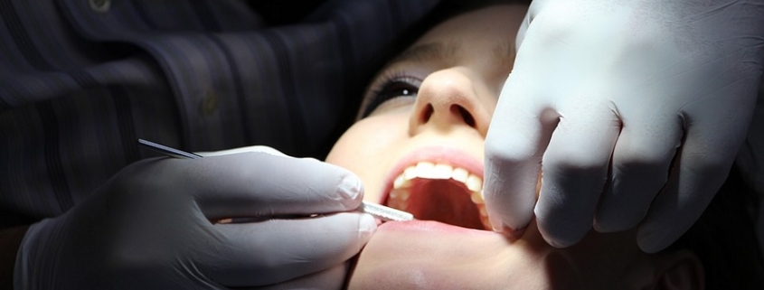 Mujer siendo intervenida por un dentista