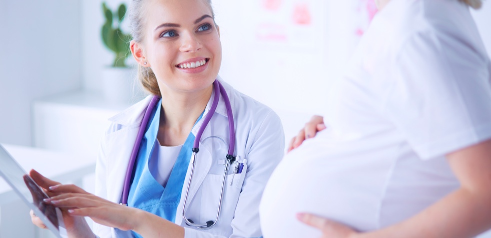 doctora hablando con una paciente embarazada sobre posibles enfermedades y los cuidados que debe de tener
