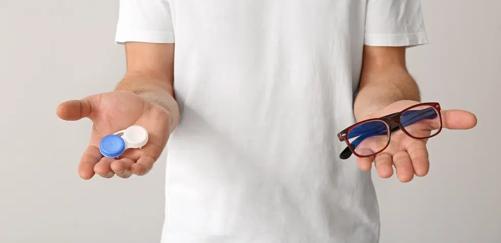 Hombre sosteniendo funda de lentillas y gafas en las manos